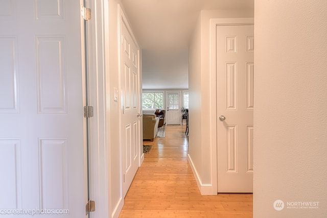 corridor with light hardwood / wood-style floors