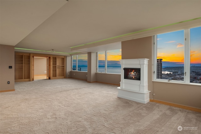 unfurnished living room with light colored carpet