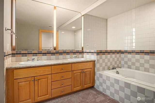 bathroom featuring vanity, tile walls, and tiled bath