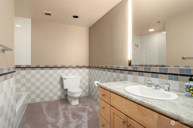 full bathroom featuring plus walk in shower, vanity, toilet, and tile walls