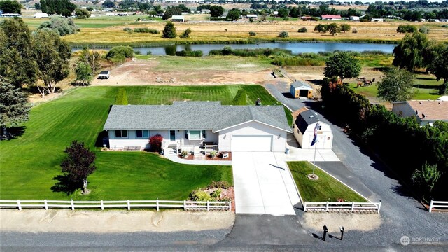 birds eye view of property with a rural view and a water view