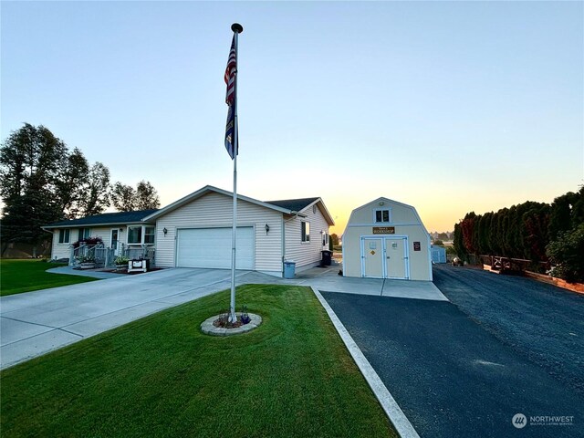 view of front facade with a storage unit and a yard