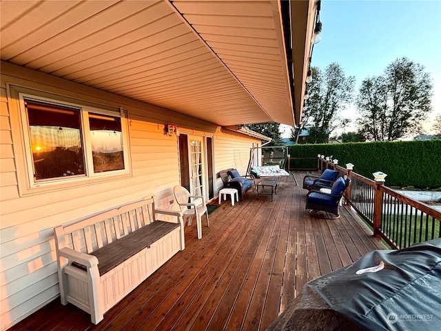 deck at dusk featuring an outdoor hangout area