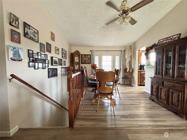 dining room with a textured ceiling, ceiling fan, and hardwood / wood-style flooring