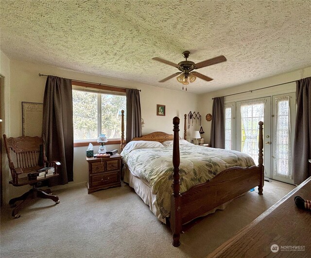 bedroom featuring ceiling fan, light carpet, access to outside, and a textured ceiling