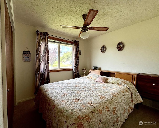 carpeted bedroom featuring a textured ceiling and ceiling fan