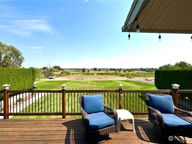 wooden terrace featuring a lawn