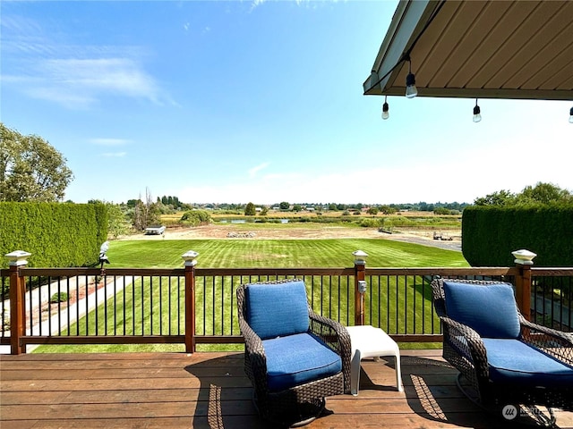 wooden terrace featuring a yard