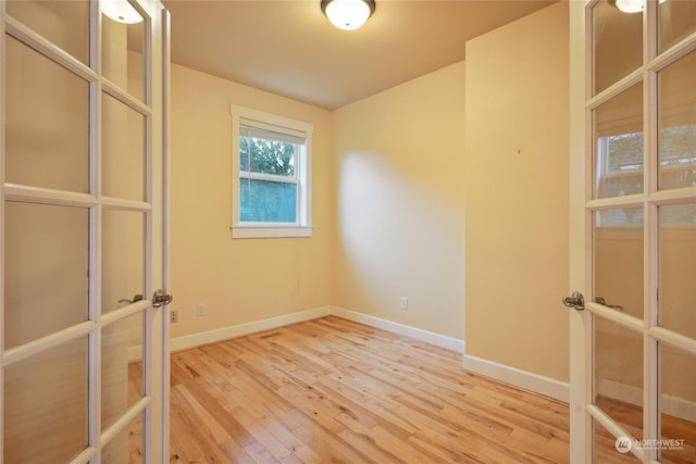 403 N I St, Tacoma, WA 98403 - unfurnished room with french doors, light wood-style flooring, and baseboards
