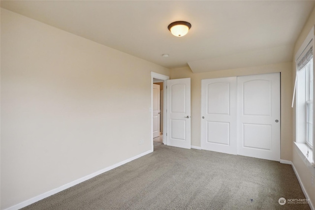 403 N I St, Tacoma, WA 98403 - unfurnished bedroom with a closet, baseboards, and carpet floors