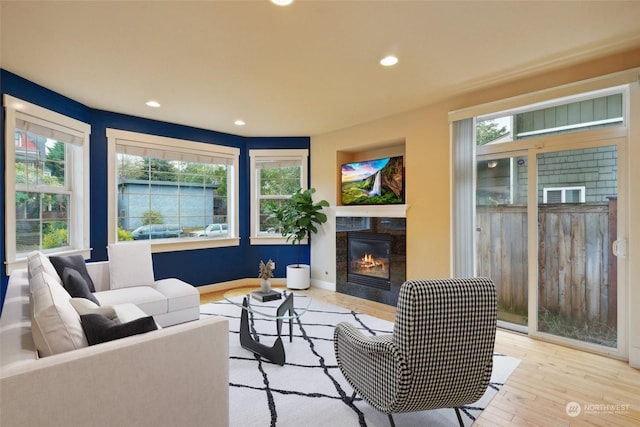 403 N I St, Tacoma, WA 98403 - living room featuring recessed lighting, wood finished floors, a high end fireplace, and a healthy amount of sunlight