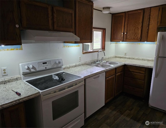 kitchen with wall chimney range hood, sink, dark hardwood / wood-style floors, and white appliances