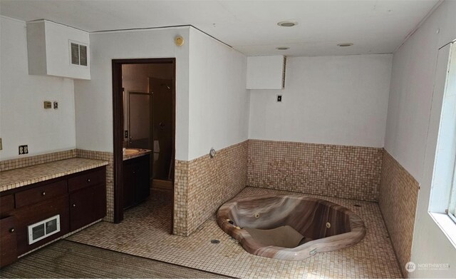 bathroom featuring a tub and vanity