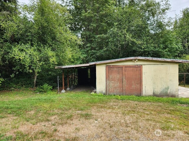 view of outdoor structure featuring a lawn