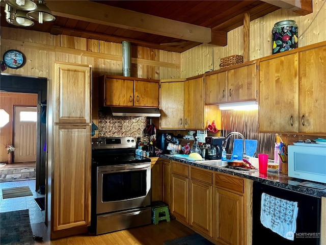 kitchen featuring white microwave, a sink, stainless steel range with electric stovetop, beamed ceiling, and under cabinet range hood