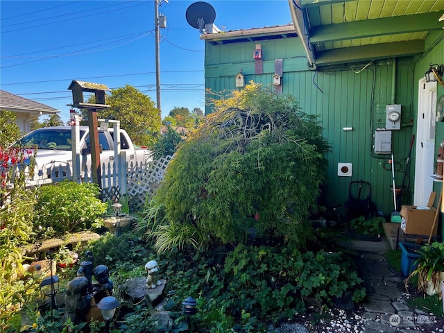 view of side of home with fence