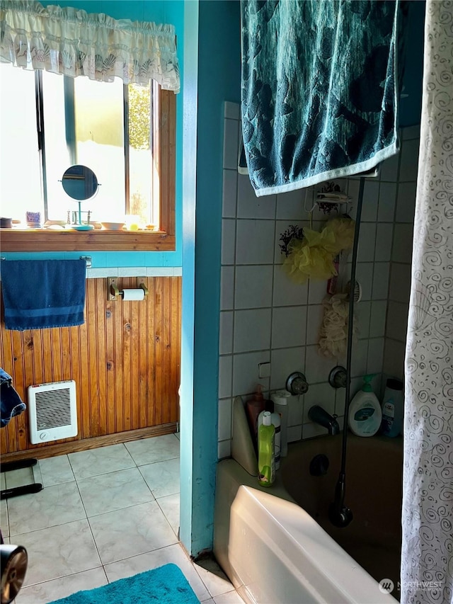 bathroom featuring tile patterned flooring, washtub / shower combination, and heating unit