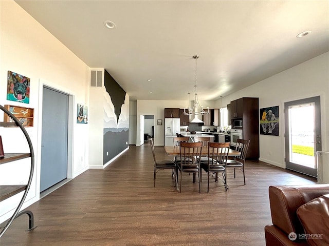 dining space with dark hardwood / wood-style flooring