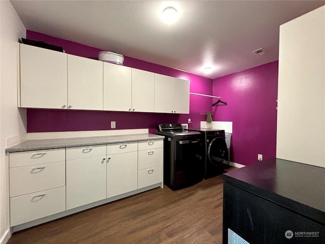 kitchen with washing machine and dryer, white cabinetry, and dark wood-type flooring