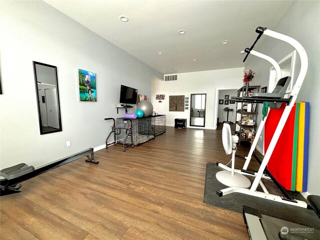 exercise area featuring hardwood / wood-style flooring and electric panel