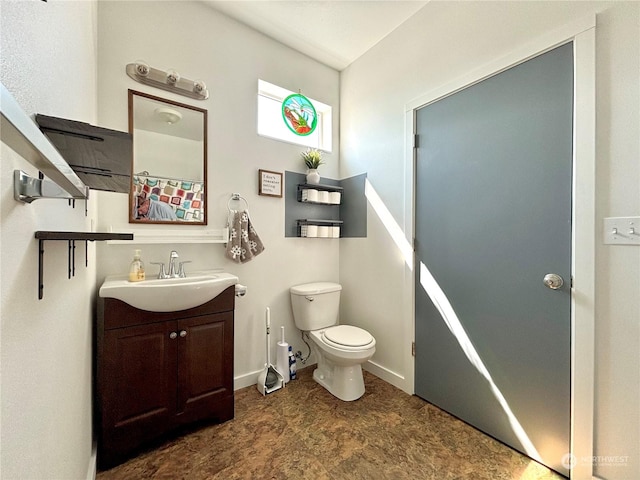 bathroom with toilet and vanity