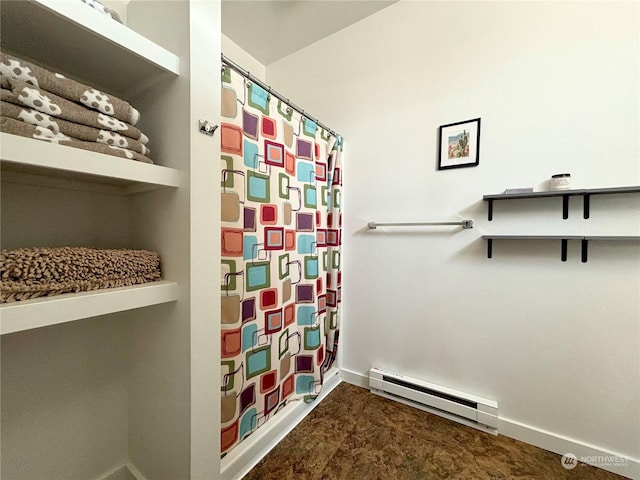 bathroom featuring a shower with curtain and baseboard heating