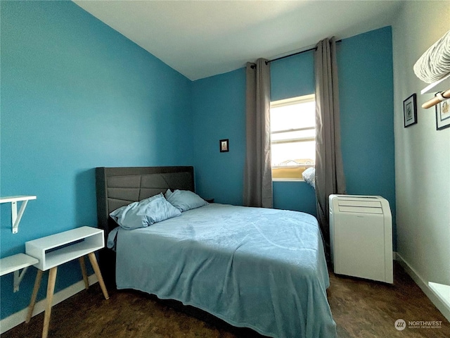 carpeted bedroom with lofted ceiling