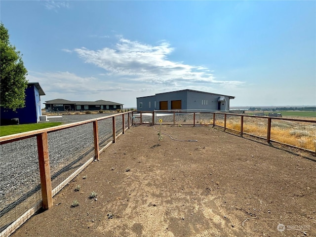 view of yard with a rural view