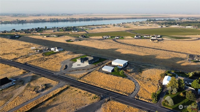 drone / aerial view featuring a rural view and a water view