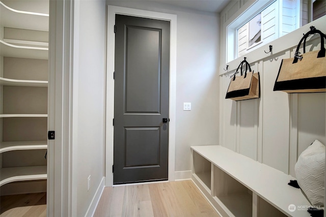 mudroom featuring baseboards and light wood finished floors