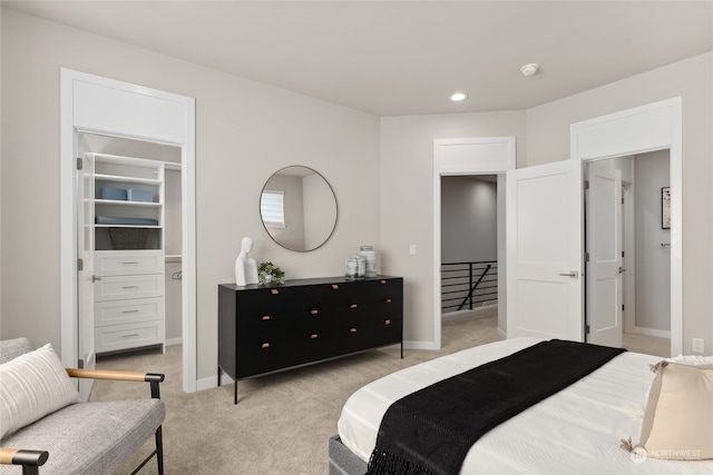 carpeted bedroom with a walk in closet