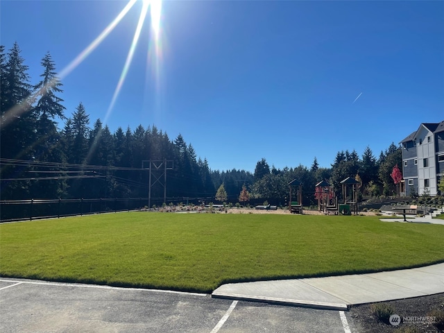 view of home's community with a lawn and a playground