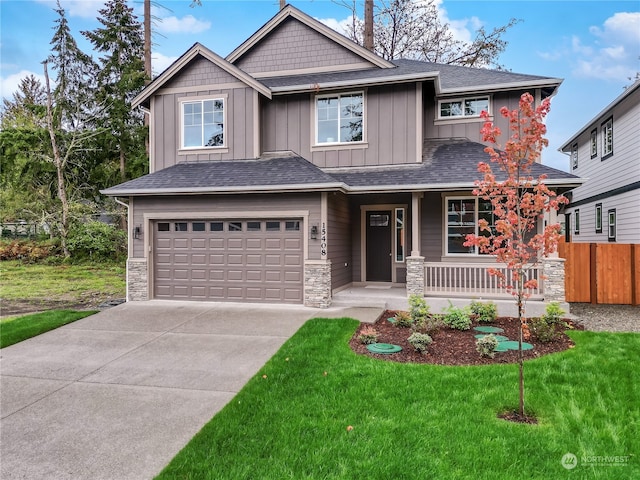 craftsman house with a porch, a garage, and a front yard