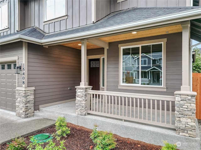 doorway to property with a porch and a garage