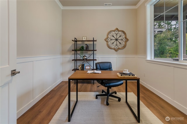 home office featuring wood-type flooring and ornamental molding