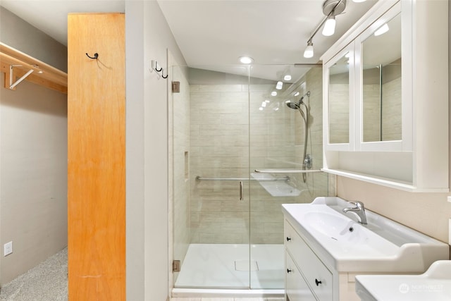 bathroom featuring vanity and an enclosed shower