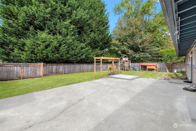 view of patio with a storage unit and a playground