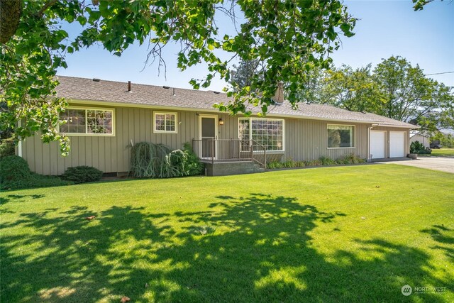 ranch-style home with a front yard and a garage