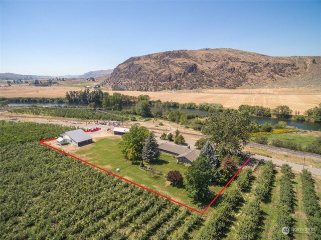 drone / aerial view featuring a rural view and a water and mountain view