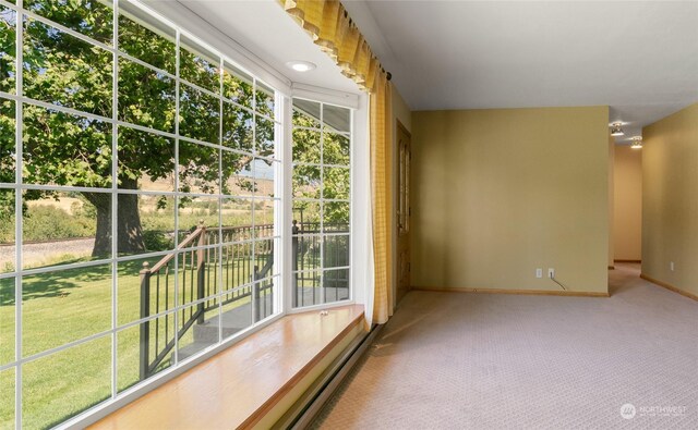 interior space with carpet and baseboards