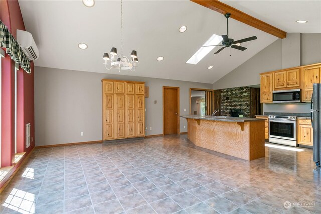 kitchen featuring a breakfast bar area, decorative light fixtures, stainless steel appliances, beam ceiling, and ceiling fan with notable chandelier