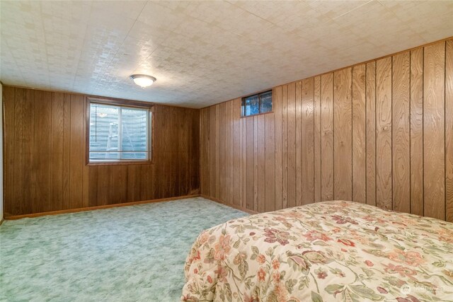 unfurnished bedroom featuring light carpet and wood walls