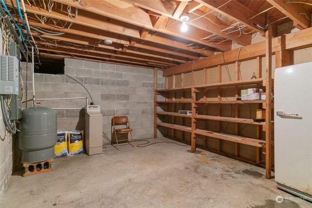 unfinished below grade area with freestanding refrigerator