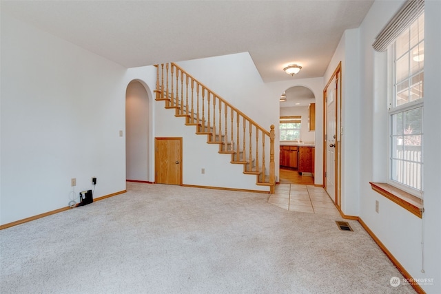 entrance foyer featuring light colored carpet