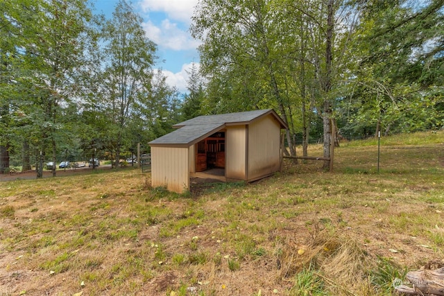 view of outbuilding with a yard