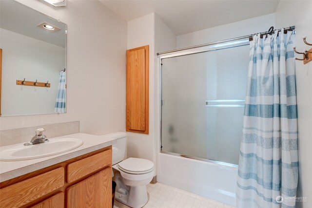 full bathroom featuring tile patterned flooring, vanity, shower / tub combo with curtain, and toilet