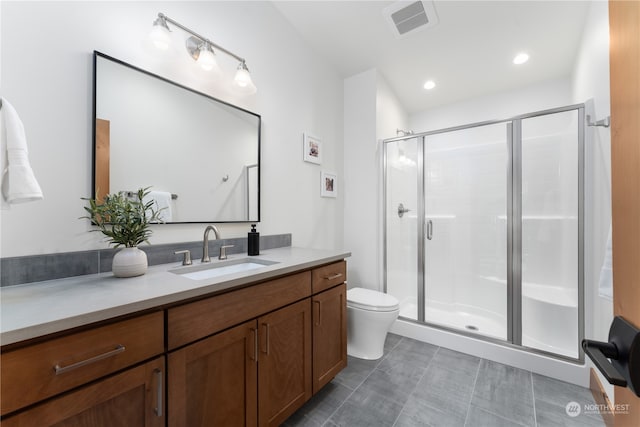 bathroom with vanity, toilet, and walk in shower