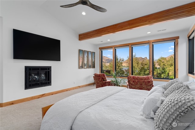 bedroom with carpet, ceiling fan, vaulted ceiling with beams, and multiple windows