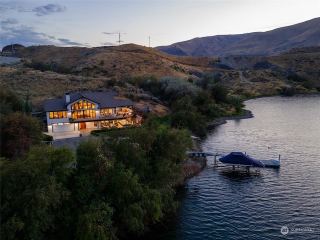 property view of water featuring a mountain view and a dock