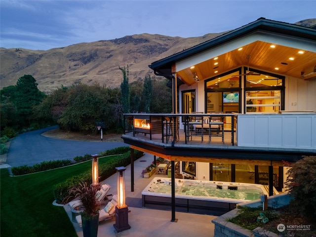 exterior space with a deck with mountain view and a yard